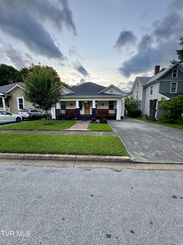 411 Clinchfield Ave, Erwin, TN 37650 - view of front of home with a porch, asphalt driveway, and a front yard