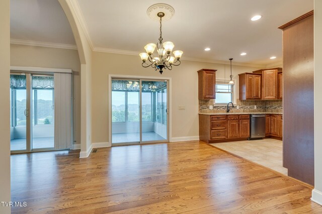 397 Ridgecrest Rd, Jonesborough, TN 37659 - kitchen with stainless steel dishwasher, brown cabinets, light wood finished floors, crown molding, and a chandelier