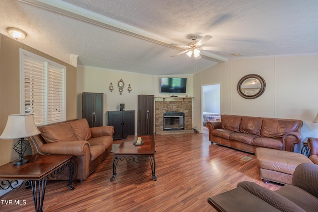 1070 Bill Martin Rd, Afton, TN 37616 - living room with wood finished floors, ceiling fan, a textured ceiling, a stone fireplace, and lofted ceiling