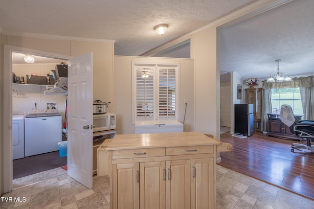 1070 Bill Martin Rd, Afton, TN 37616 - kitchen featuring independent washer and dryer, white microwave, a textured ceiling, ornamental molding, and butcher block counters