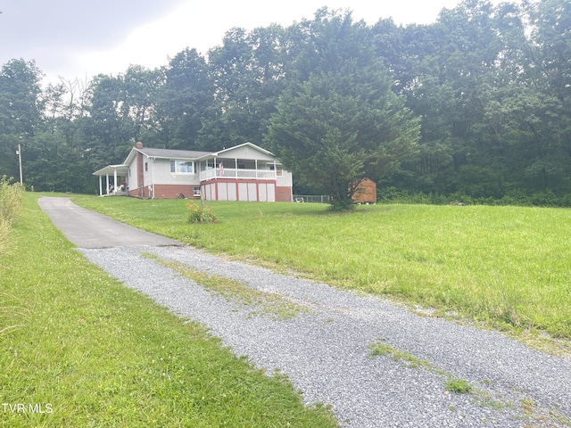 134 Carver Crabtree Rd, Hampton, TN 37658 - ranch-style home with driveway, a view of trees, a front lawn, and a chimney