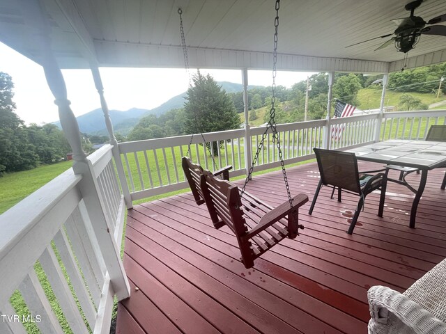 134 Carver Crabtree Rd, Hampton, TN 37658 - deck featuring a ceiling fan, a mountain view, outdoor dining area, and a yard