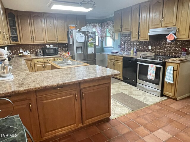 134 Carver Crabtree Rd, Hampton, TN 37658 - kitchen featuring black appliances, under cabinet range hood, tasteful backsplash, light countertops, and ornamental molding
