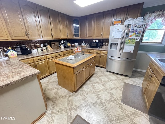 134 Carver Crabtree Rd, Hampton, TN 37658 - kitchen featuring stainless steel fridge with ice dispenser, tasteful backsplash, light countertops, a center island, and black microwave