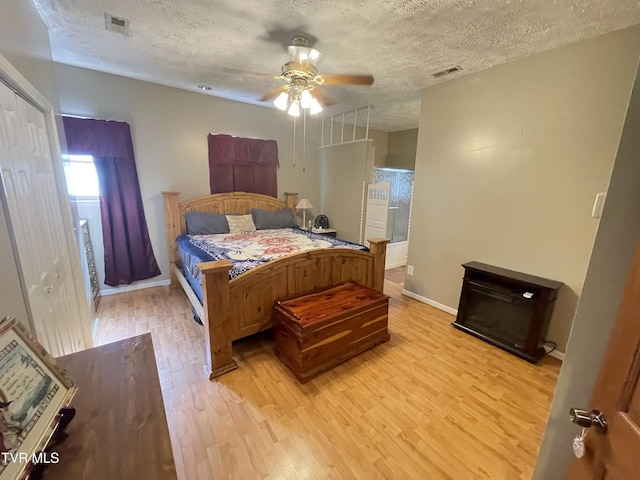 134 Carver Crabtree Rd, Hampton, TN 37658 - bedroom featuring a textured ceiling, light wood-style flooring, and ceiling fan
