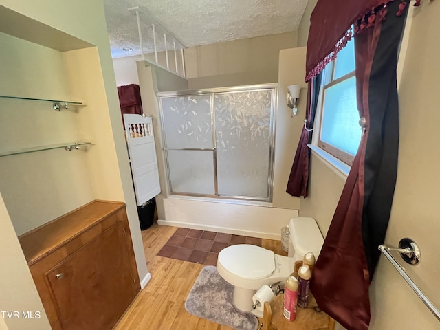 134 Carver Crabtree Rd, Hampton, TN 37658 - bathroom featuring a shower with door, a textured ceiling, and wood finished floors
