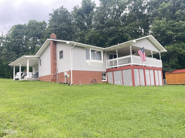 134 Carver Crabtree Rd, Hampton, TN 37658 - view of front of property featuring a front lawn, a chimney, an attached carport, and view of scattered trees