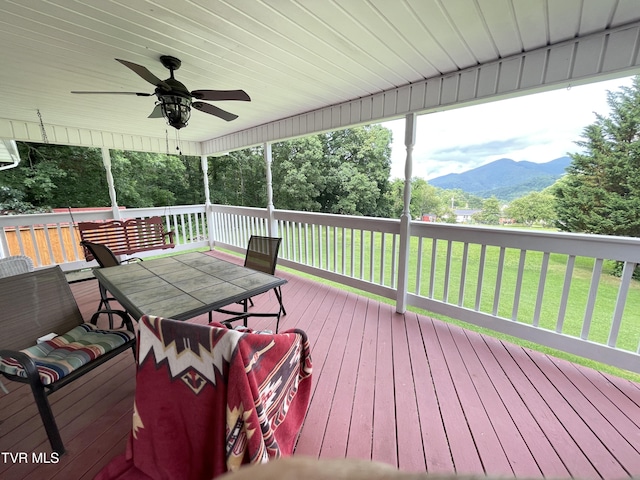 134 Carver Crabtree Rd, Hampton, TN 37658 - wooden deck featuring a mountain view, outdoor dining area, ceiling fan, and a yard
