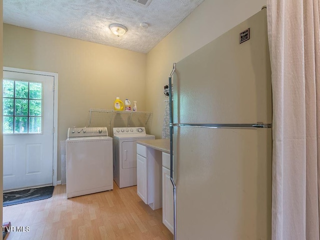 134 Carver Crabtree Rd, Hampton, TN 37658 - laundry room featuring light wood-type flooring, independent washer and dryer, cabinet space, and a textured ceiling