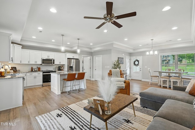 107 Ervin Loop, Erwin, TN 37650 - living area featuring a tray ceiling, a ceiling fan, light wood-type flooring, recessed lighting, and a chandelier