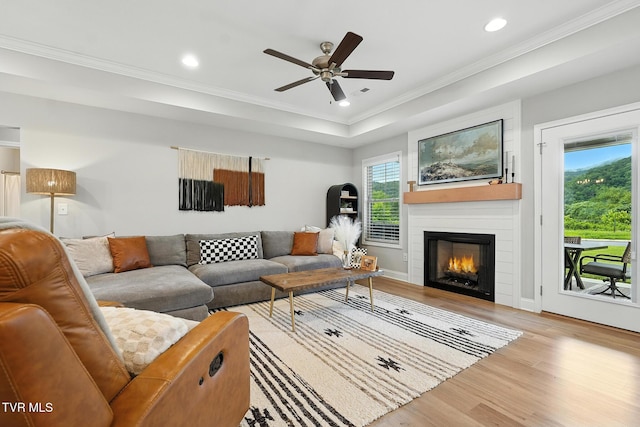 107 Ervin Loop, Erwin, TN 37650 - living area featuring wood finished floors, ceiling fan, a large fireplace, recessed lighting, and crown molding