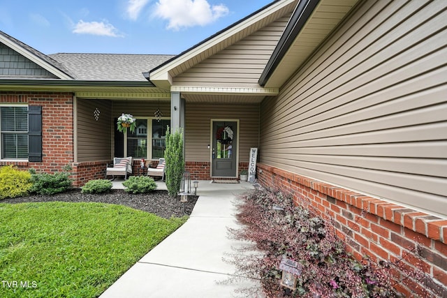 107 Ervin Loop, Erwin, TN 37650 - doorway to property featuring brick siding, covered porch, and a shingled roof