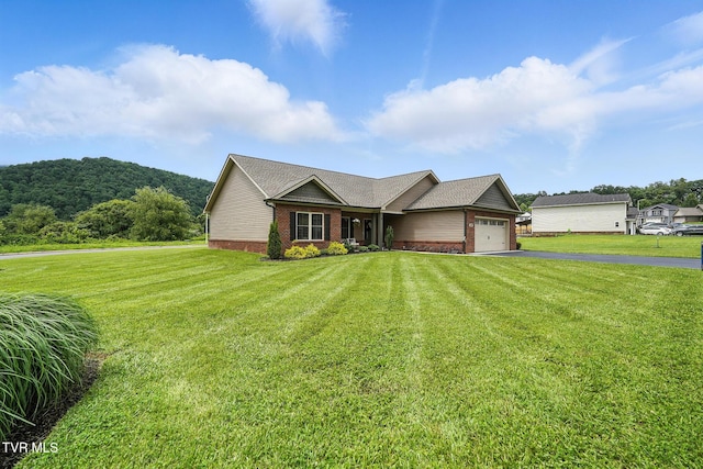107 Ervin Loop, Erwin, TN 37650 - single story home featuring brick siding, asphalt driveway, an attached garage, and a front yard