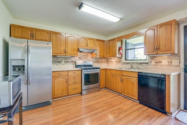 151 Woodcrest Ln Unit 0, Bristol, VA 24201 - kitchen with appliances with stainless steel finishes, under cabinet range hood, light countertops, light wood-type flooring, and ornamental molding