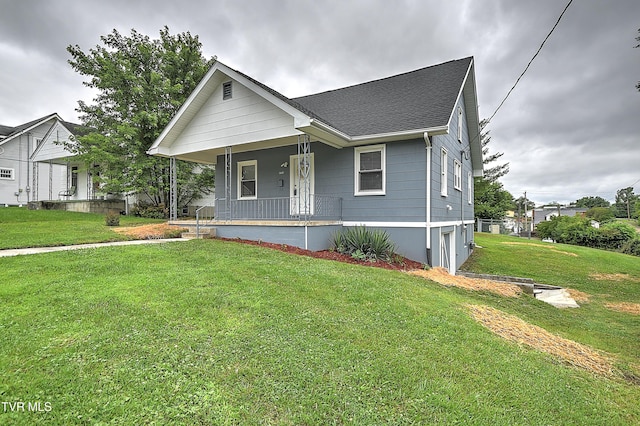 1648 E St, Kingsport, TN 37664 - bungalow featuring covered porch, a front yard, and roof with shingles