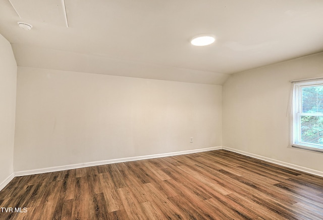 1648 E St, Kingsport, TN 37664 - bonus room featuring vaulted ceiling, dark wood-style flooring, and attic access
