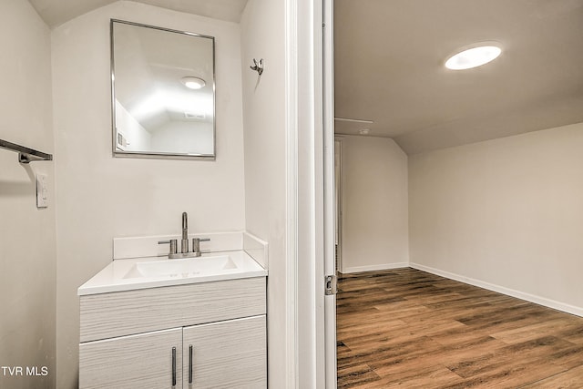 1648 E St, Kingsport, TN 37664 - bathroom featuring lofted ceiling, vanity, and wood finished floors