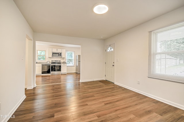 1648 E St, Kingsport, TN 37664 - unfurnished living room with dark wood finished floors