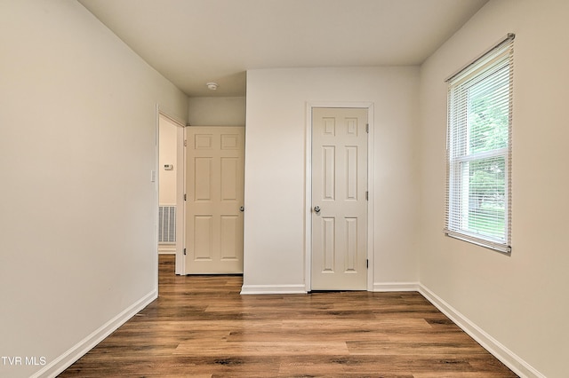 1648 E St, Kingsport, TN 37664 - unfurnished bedroom featuring wood finished floors and baseboards