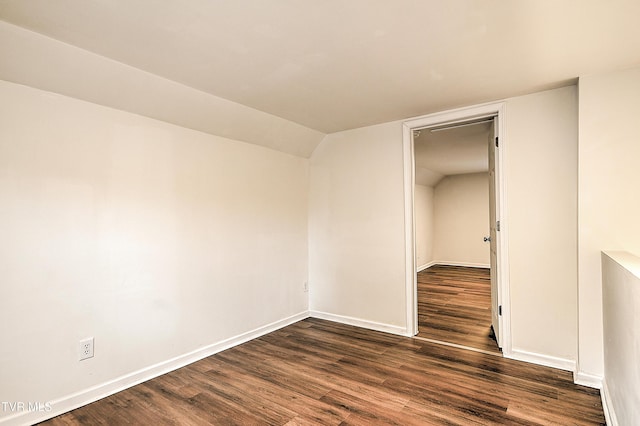 1648 E St, Kingsport, TN 37664 - unfurnished room with dark wood-style floors and vaulted ceiling