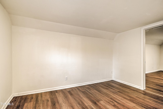 1648 E St, Kingsport, TN 37664 - unfurnished room featuring dark wood-type flooring and vaulted ceiling