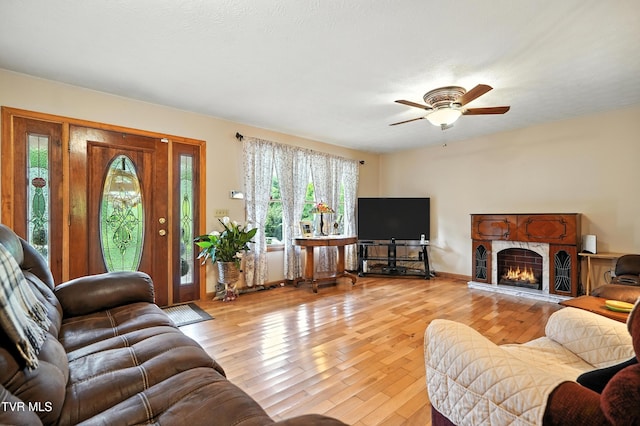 1037 Swift Hollow Rd, Mountain City, TN 37683 - living area with hardwood / wood-style floors, a ceiling fan, and a lit fireplace