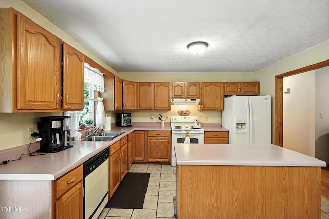 1037 Swift Hollow Rd, Mountain City, TN 37683 - kitchen with white appliances, under cabinet range hood, light countertops, a kitchen island, and brown cabinetry