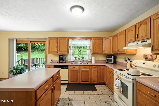 1037 Swift Hollow Rd, Mountain City, TN 37683 - kitchen featuring white appliances, under cabinet range hood, light countertops, a textured ceiling, and brown cabinetry
