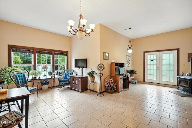 1037 Swift Hollow Rd, Mountain City, TN 37683 - living room with a chandelier, a wood stove, light tile patterned flooring, and a high ceiling