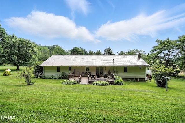 1037 Swift Hollow Rd, Mountain City, TN 37683 - back of property with a yard, a wooden deck, a metal roof, and a chimney