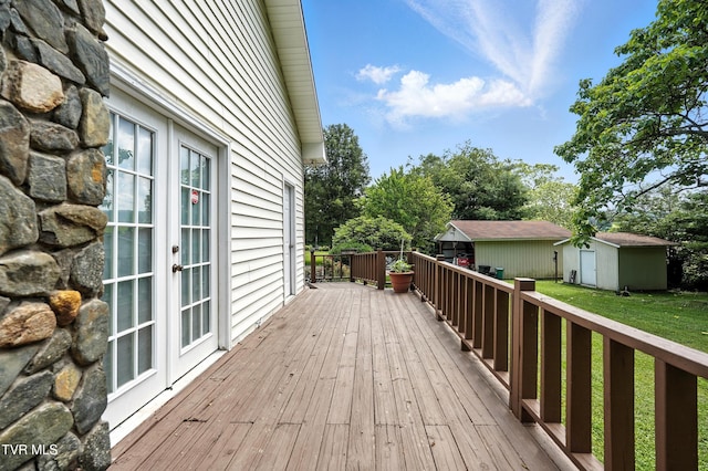 1037 Swift Hollow Rd, Mountain City, TN 37683 - wooden terrace featuring french doors, a storage shed, and a lawn