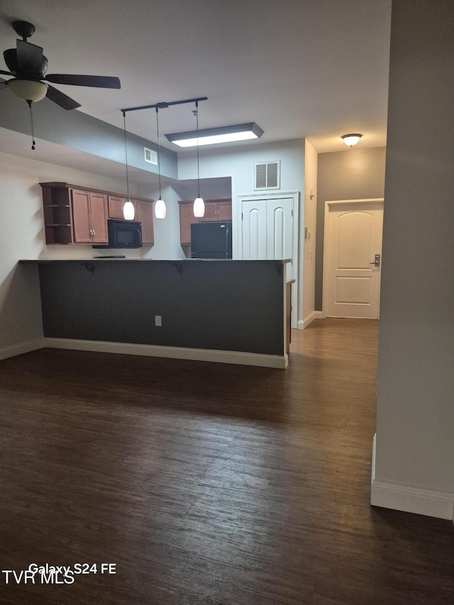 116 Tipton St Unit 209, Johnson City, TN 37604 - kitchen featuring black microwave, a peninsula, ceiling fan, and dark wood-type flooring
