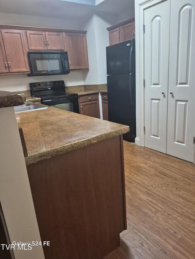 116 Tipton St Unit 209, Johnson City, TN 37604 - kitchen featuring black appliances and light wood-type flooring
