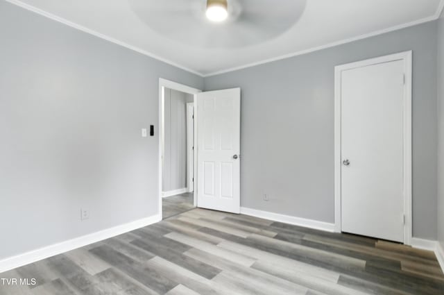 3974 Memorial Blvd, Kingsport, TN 37664 - unfurnished bedroom featuring crown molding, wood finished floors, and a ceiling fan