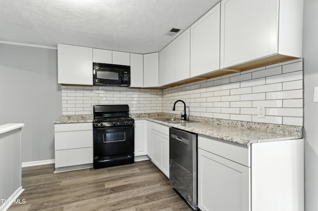 3974 Memorial Blvd, Kingsport, TN 37664 - kitchen with black appliances, white cabinets, wood finished floors, and a textured ceiling