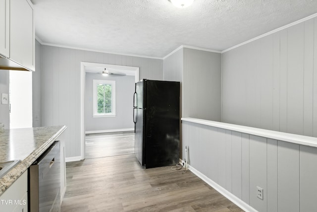 3974 Memorial Blvd, Kingsport, TN 37664 - kitchen featuring freestanding refrigerator, stainless steel dishwasher, crown molding, light wood-style flooring, and white cabinetry