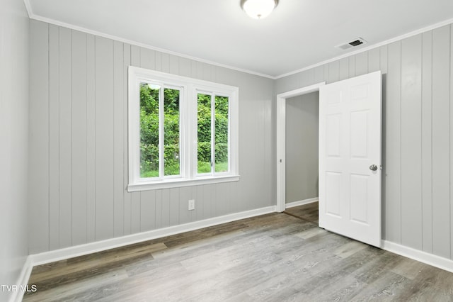 3974 Memorial Blvd, Kingsport, TN 37664 - unfurnished bedroom with ornamental molding, wood finished floors, and multiple windows