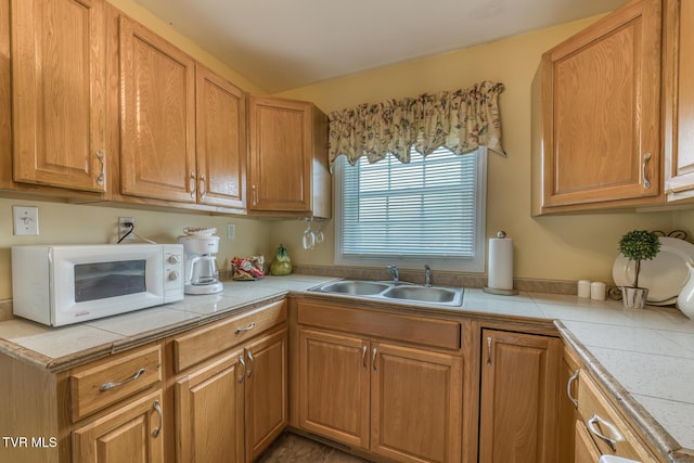 2344 Anderson St, Bristol, TN 37620 - kitchen with white microwave, brown cabinets, and tile countertops