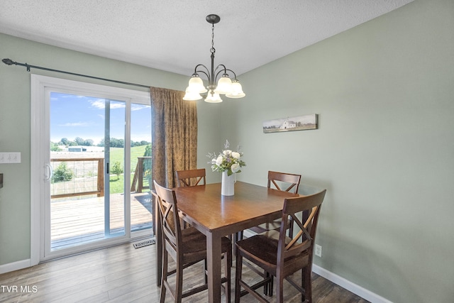 3500 Old Stage Rd, Chuckey, TN 37641 - dining space featuring a chandelier, wood finished floors, and a textured ceiling