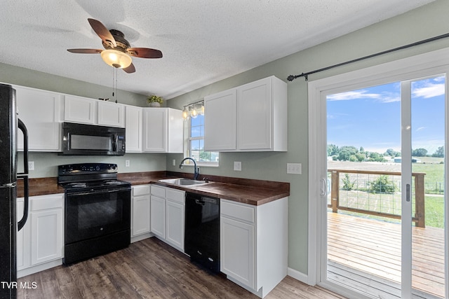 3500 Old Stage Rd, Chuckey, TN 37641 - kitchen with black appliances, dark wood-type flooring, white cabinetry, and a textured ceiling