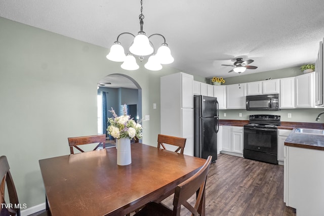 3500 Old Stage Rd, Chuckey, TN 37641 - dining space with arched walkways, a chandelier, a ceiling fan, dark wood-type flooring, and a textured ceiling