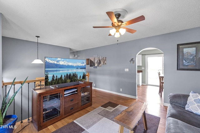 3500 Old Stage Rd, Chuckey, TN 37641 - living area featuring arched walkways, a ceiling fan, wood finished floors, and a textured ceiling