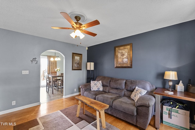 3500 Old Stage Rd, Chuckey, TN 37641 - living area with a ceiling fan, wood finished floors, arched walkways, a chandelier, and a textured ceiling