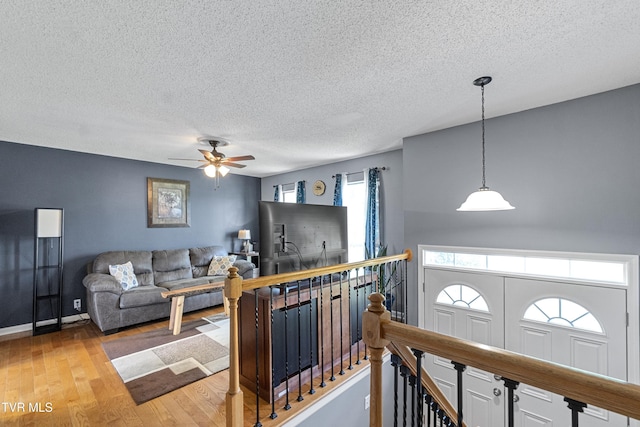 3500 Old Stage Rd, Chuckey, TN 37641 - living room with a textured ceiling, a ceiling fan, and light wood finished floors