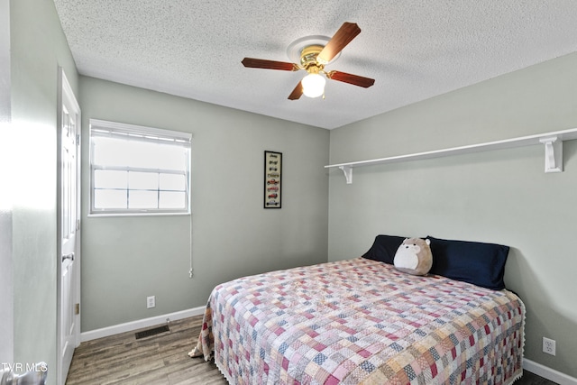 3500 Old Stage Rd, Chuckey, TN 37641 - bedroom featuring wood finished floors, a textured ceiling, and ceiling fan