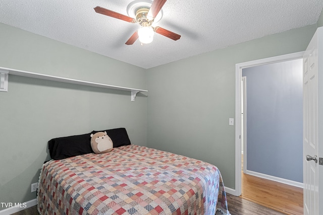 3500 Old Stage Rd, Chuckey, TN 37641 - bedroom featuring wood finished floors, a textured ceiling, and a ceiling fan