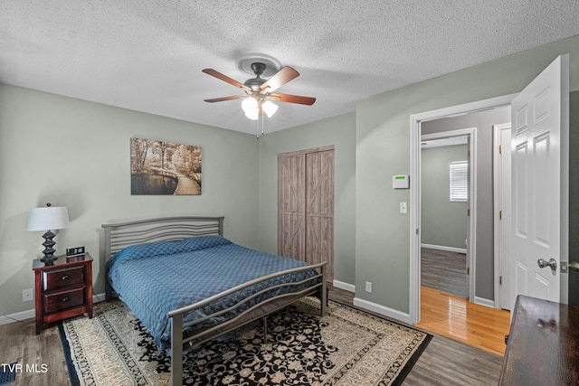 3500 Old Stage Rd, Chuckey, TN 37641 - bedroom with wood finished floors, a closet, a textured ceiling, and ceiling fan