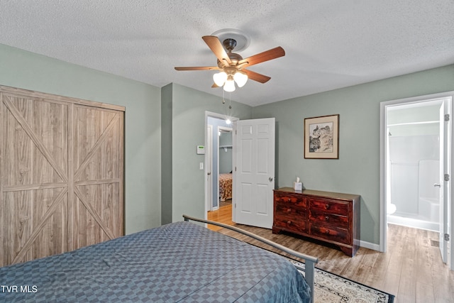 3500 Old Stage Rd, Chuckey, TN 37641 - bedroom with wood finished floors, a textured ceiling, a ceiling fan, and ensuite bath