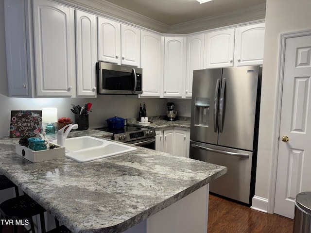 700 NW The Terrace St Unit D, Norton, VA 24273 - kitchen featuring stainless steel appliances, a peninsula, dark wood finished floors, white cabinets, and a kitchen bar