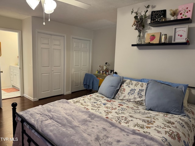 700 NW The Terrace St Unit D, Norton, VA 24273 - bedroom with dark wood-style floors, two closets, ensuite bath, and a ceiling fan